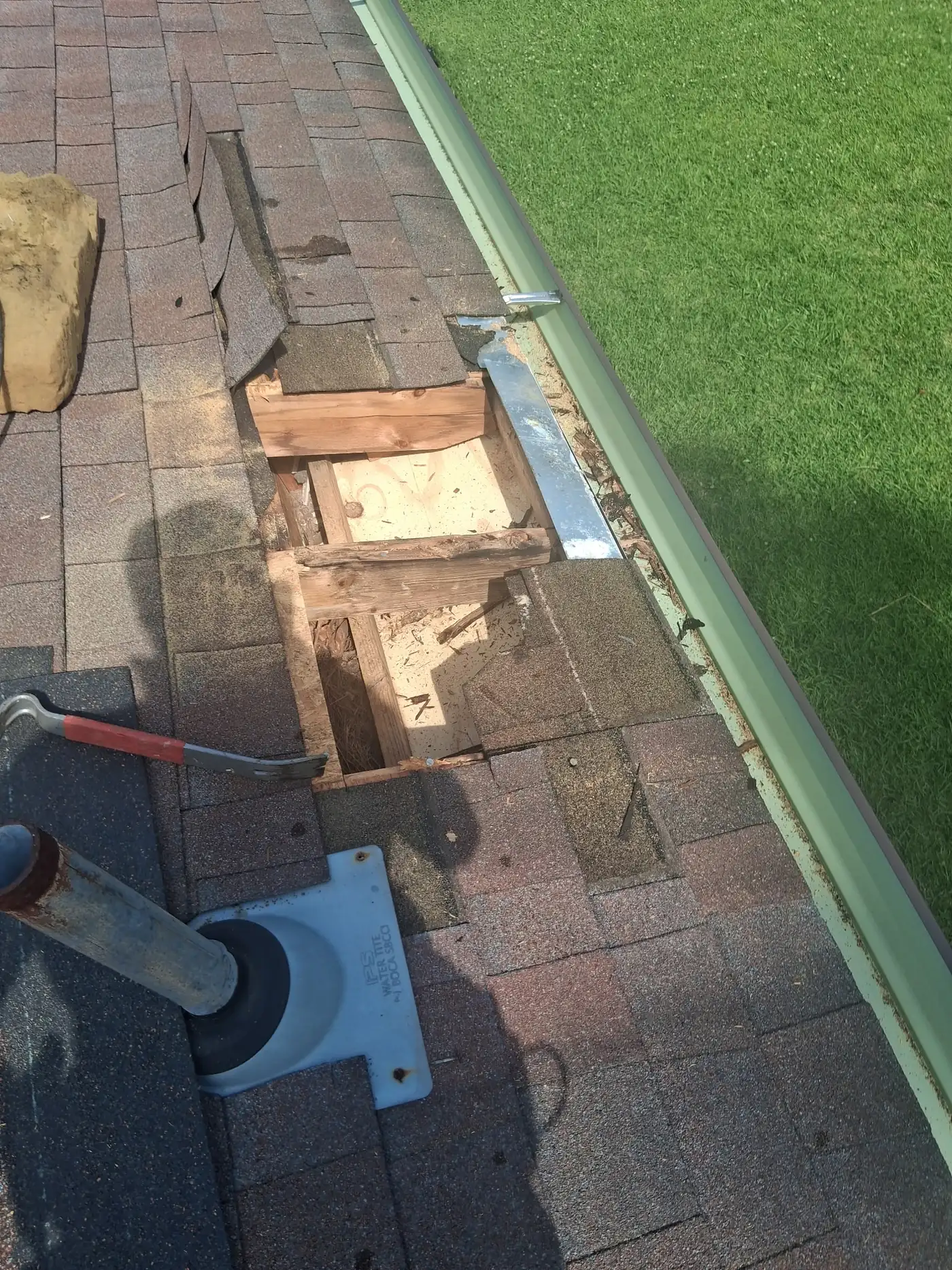 Rotted roof decking cut out and documented during a repair